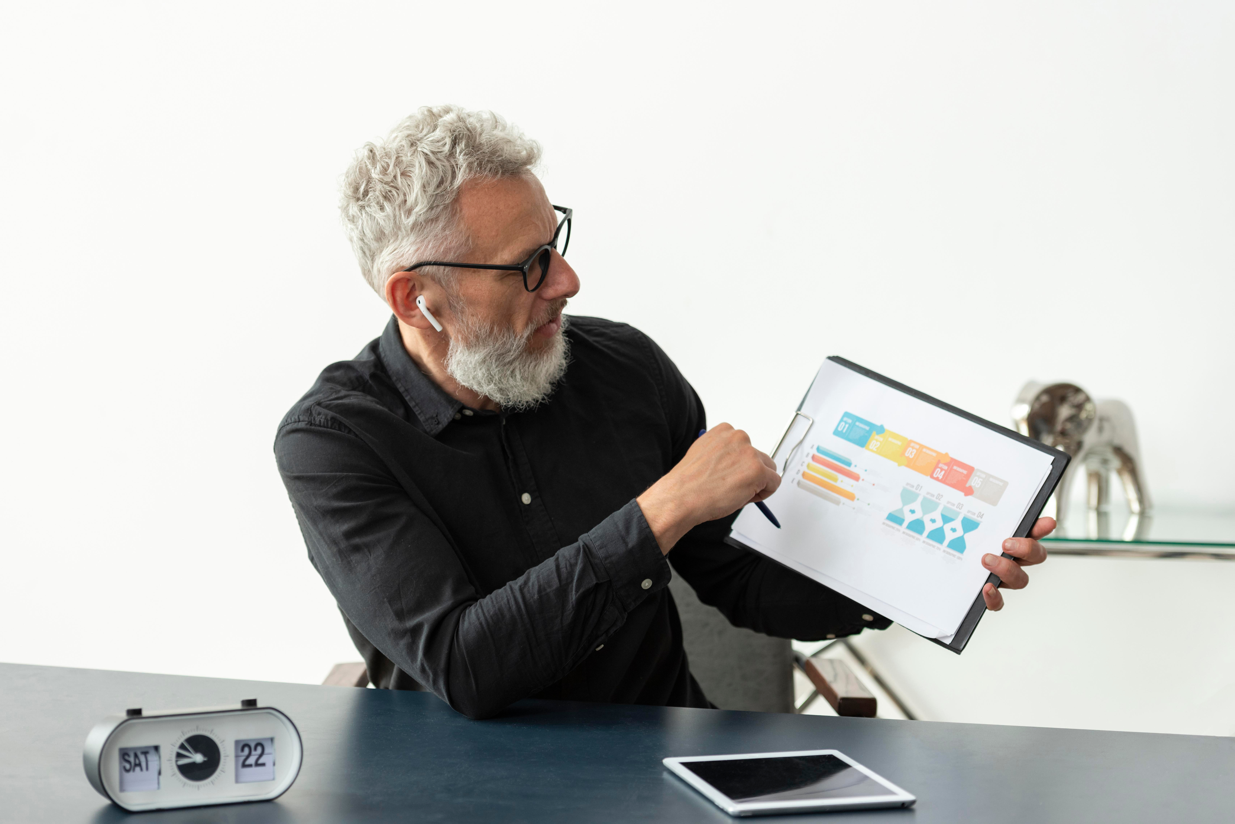 Man presenting charts on a screen