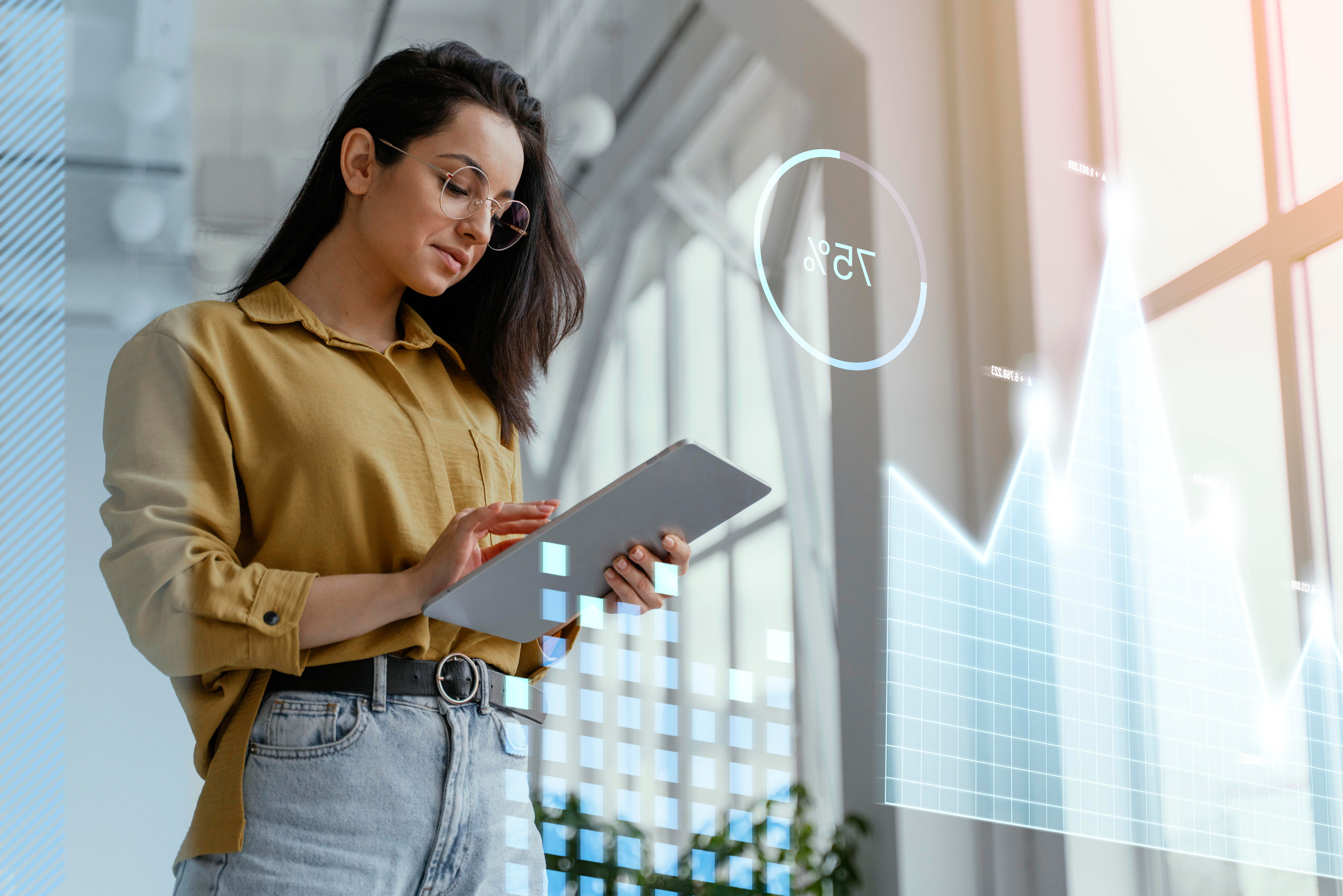 Woman using a tablet with data visualizations